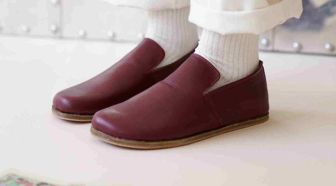 A women who wear a comfortable burgundy barefoot loafer.
