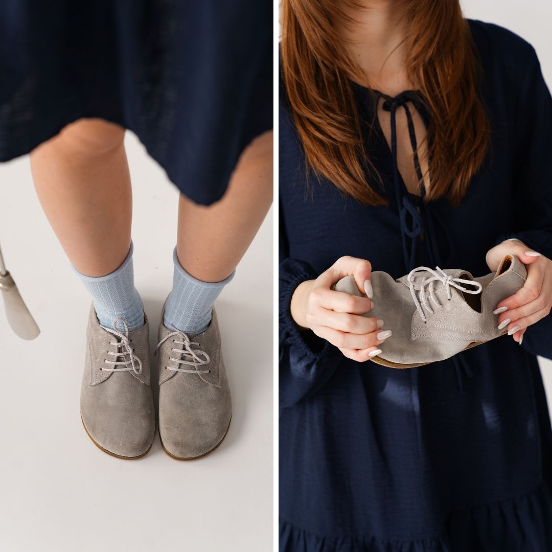 Close-up of woman in grey suede shoes, also holding the flexible shoe.