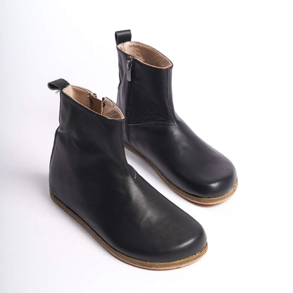 Chic black women’s boots with a wide toe box and ergonomic soles. Minimalist design perfect for everyday earthing.