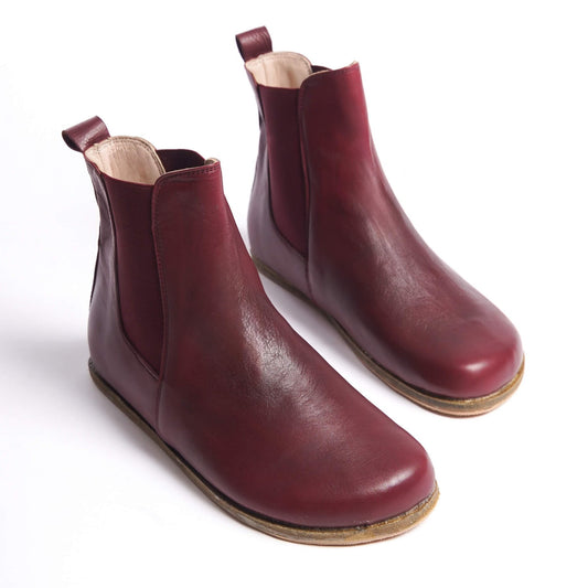 Burgundy Chelsea boots for women with a wide toe box, crafted from natural leather. Ideal for a minimalist and comfortable style.