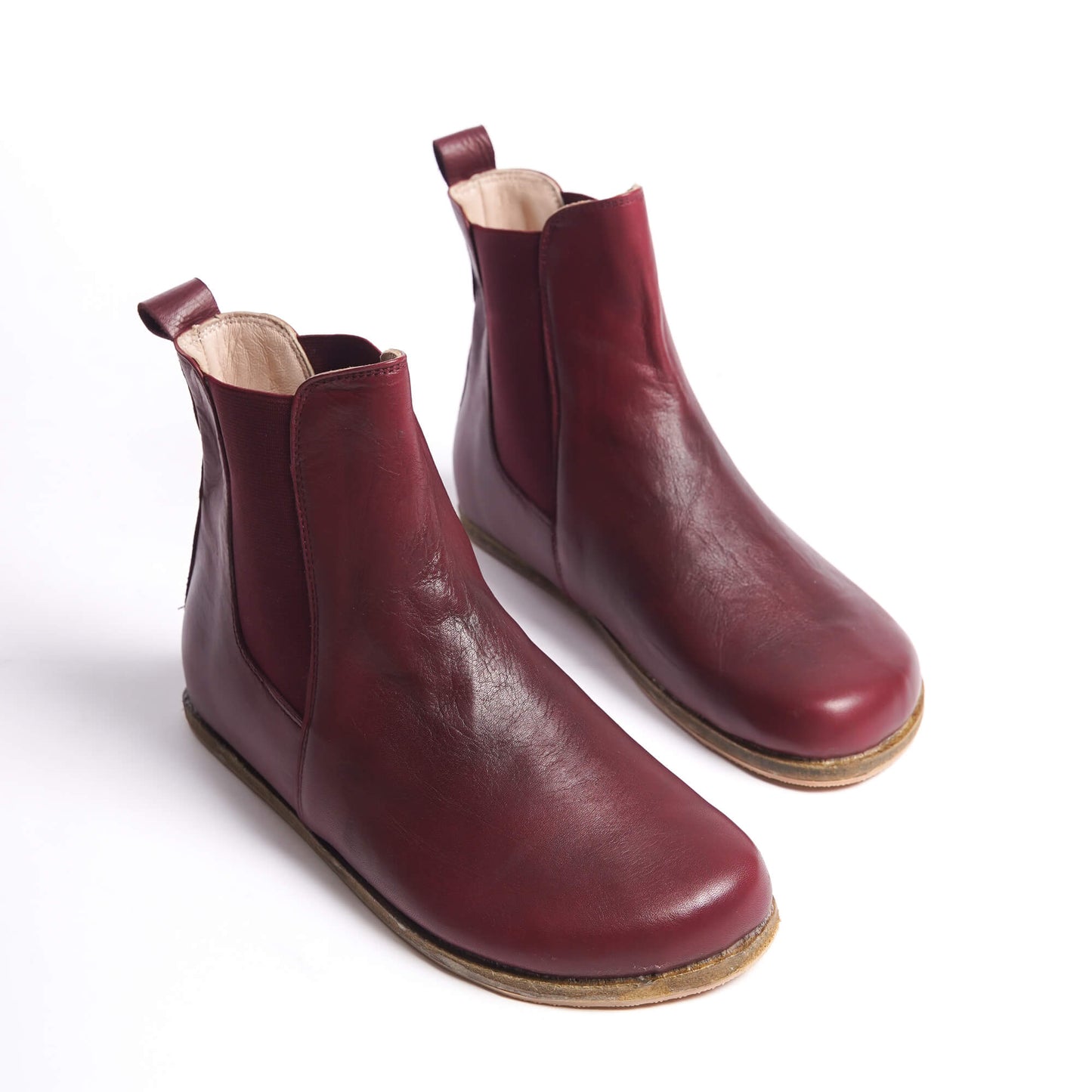 Burgundy Chelsea boots for women with a wide toe box, crafted from natural leather. Ideal for a minimalist and comfortable style.