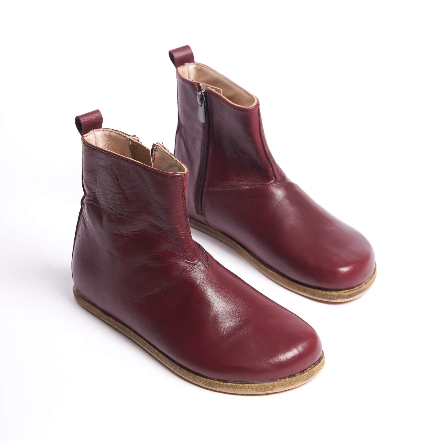 Burgundy women’s boots with a wide toe box and ergonomic soles. Minimalist design perfect for earthing shoes.