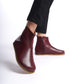 Burgundy wide boots with ergonomic soles and minimalist design. Ideal for women seeking comfortable earthing shoes.