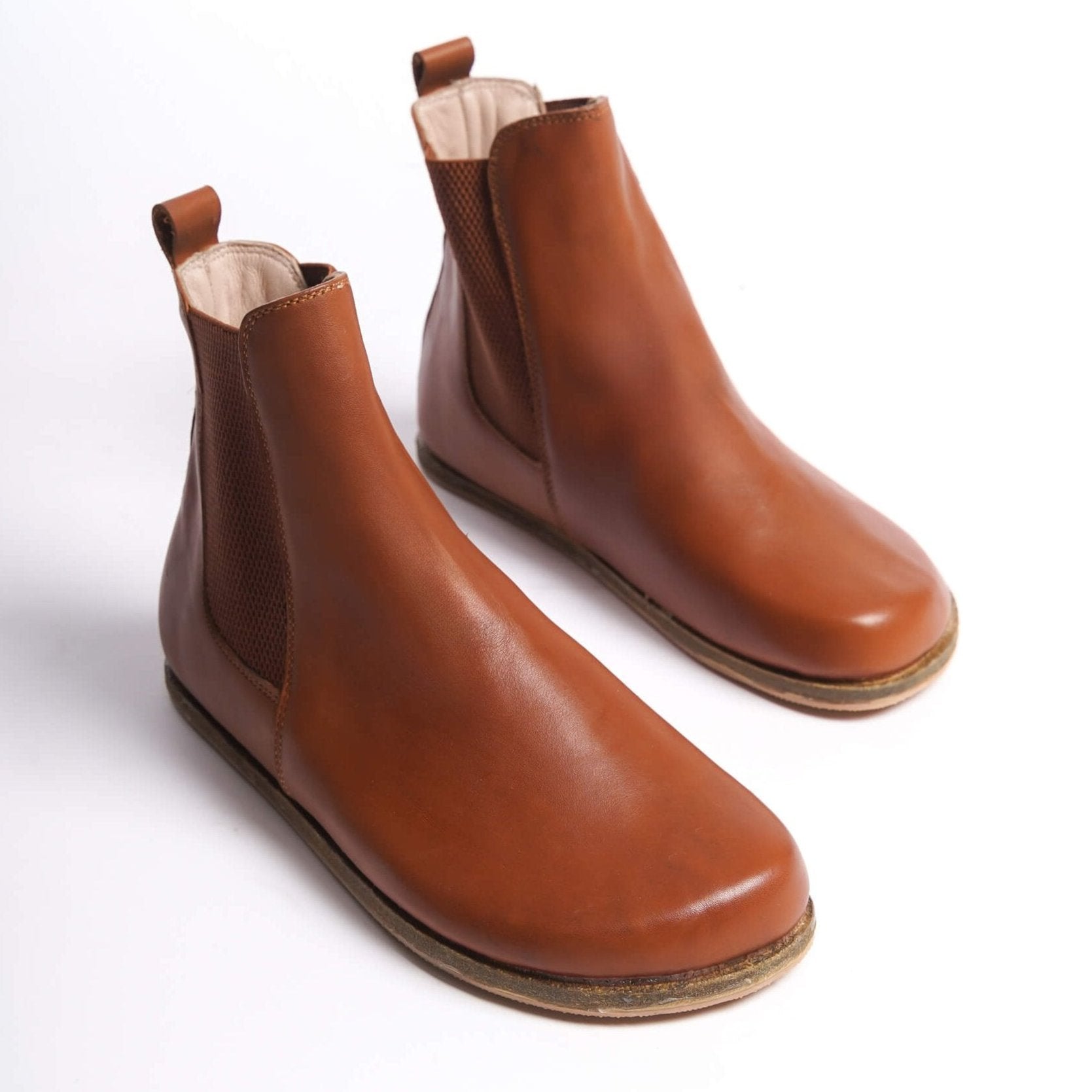 Tan brown Chelsea boots for women with a wide toe box, made from natural leather. Perfect for a minimalist look and comfort.