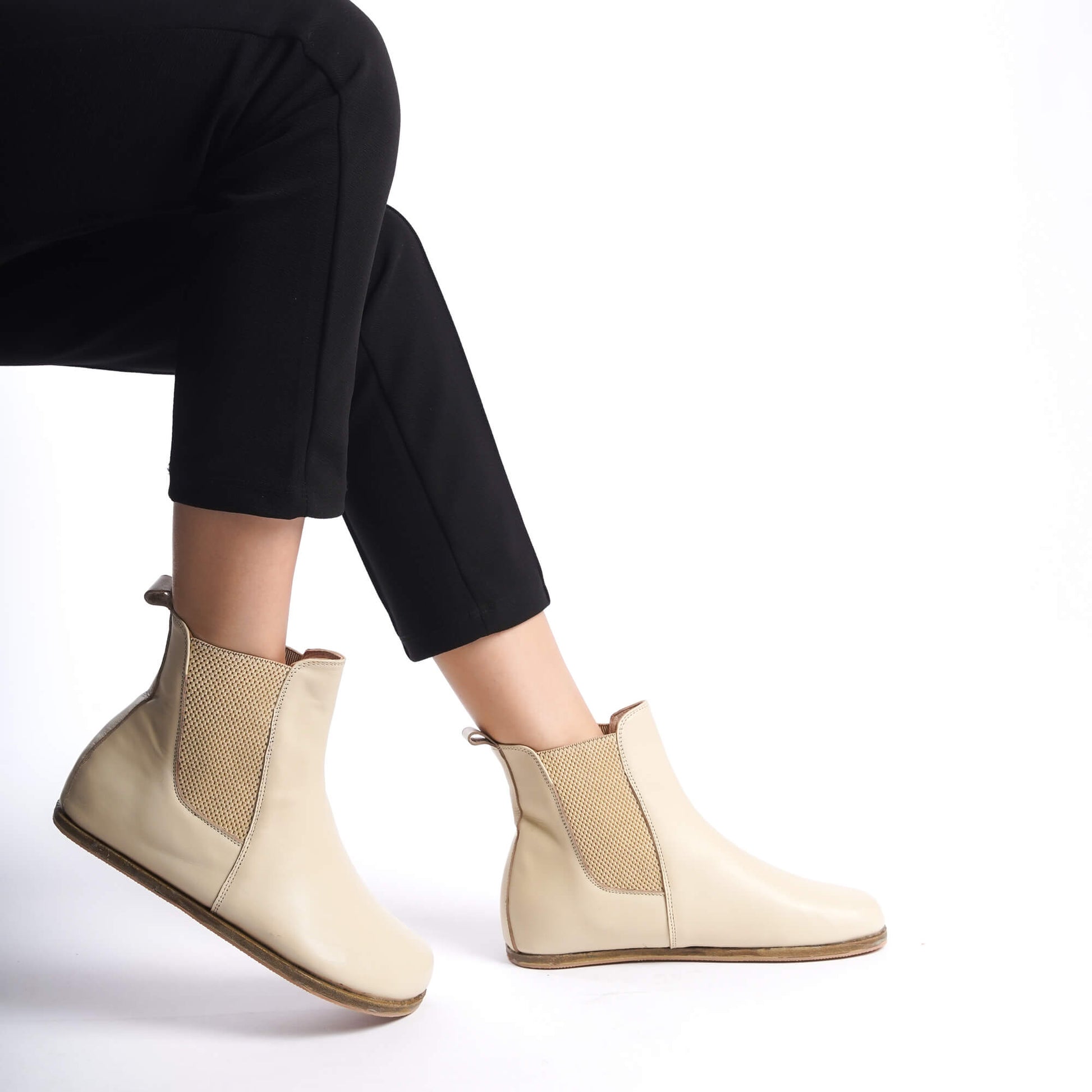 Elegant cream Chelsea boots featuring a wide toe box and crafted from genuine natural leather. Ideal for stylish and comfortable wear.