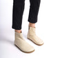 Beige-colored wide boots with ergonomic soles. Minimalist design perfect for women seeking comfortable earthing shoes.