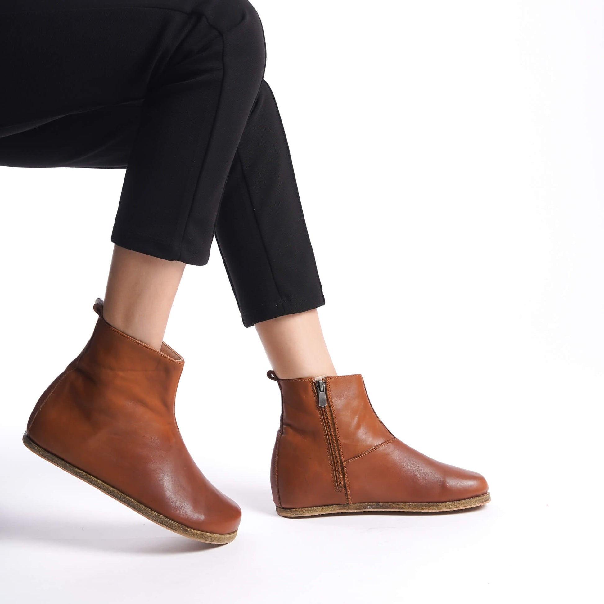 Comfortable tan brown leather wide boots for women. Ergonomic soles and minimalist style ideal for natural earthing.