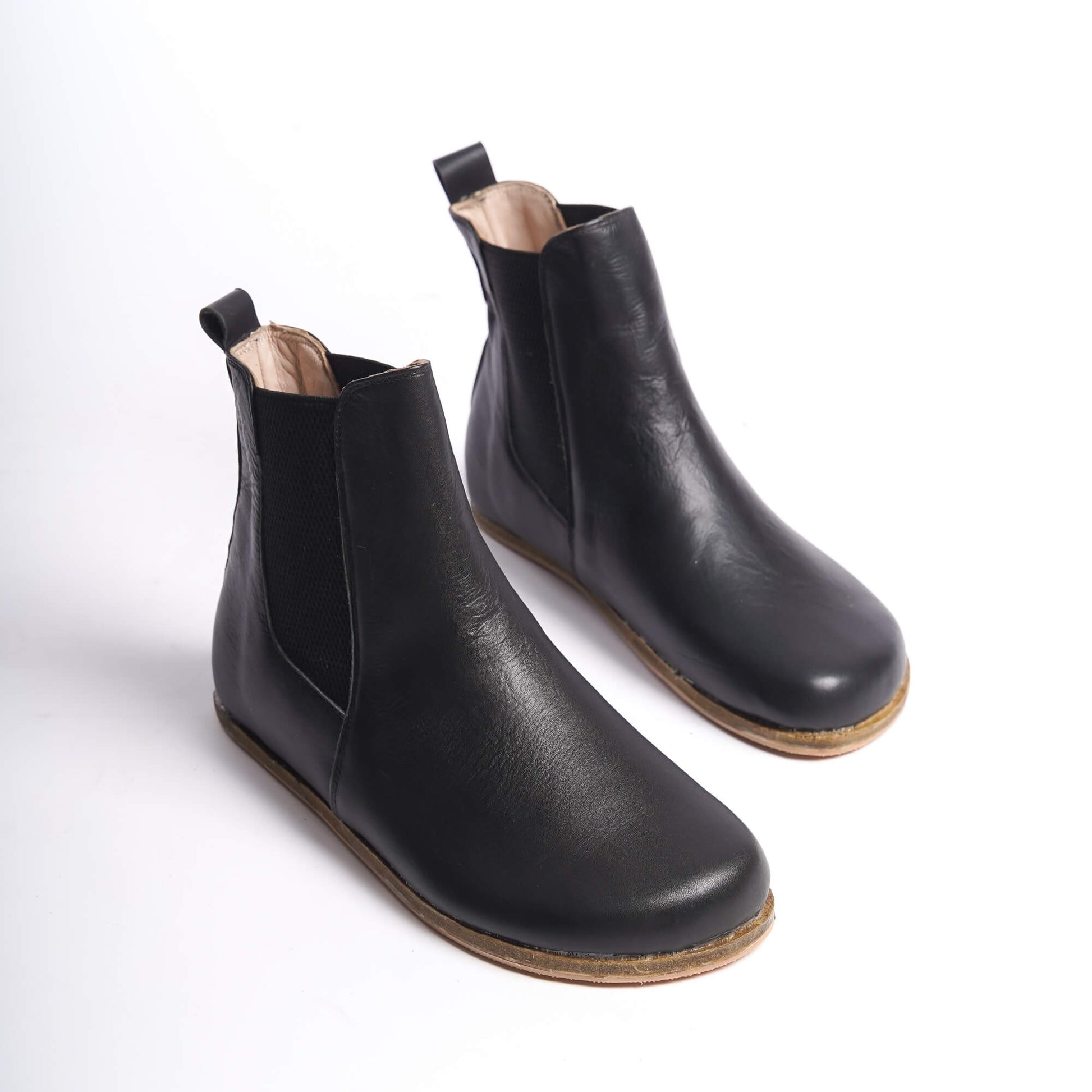 Black Chelsea boots for women with a wide toe box, crafted from premium natural leather. Ideal for minimalist style and ultimate comfort.