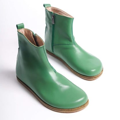 Green women’s boots with a wide toe box and ergonomic soles. Minimalist design perfect for earthing shoes.