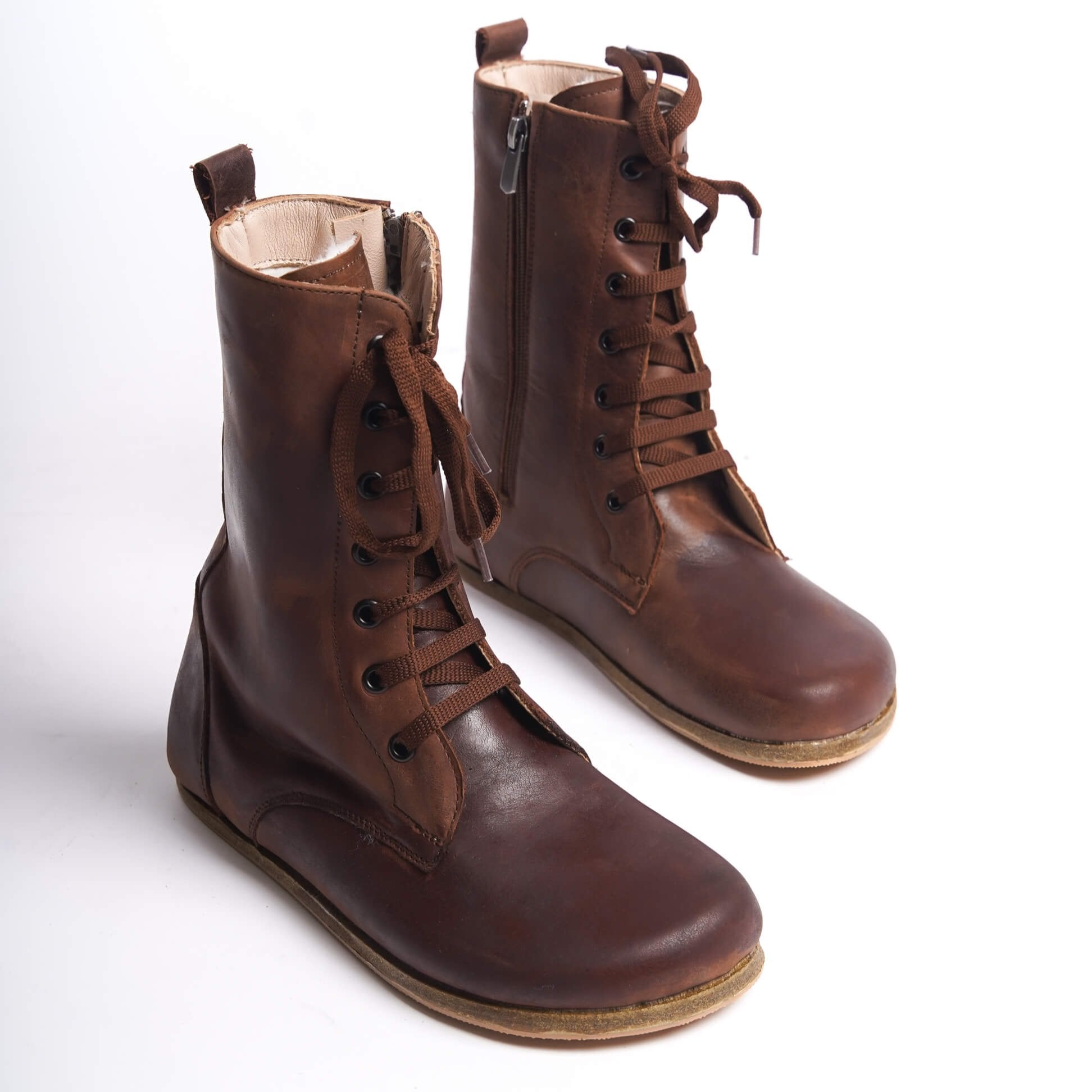 Women’s high ankle lace-up boots made from genuine natural leather in brown. Lightweight and flexible sole for maximum comfort.