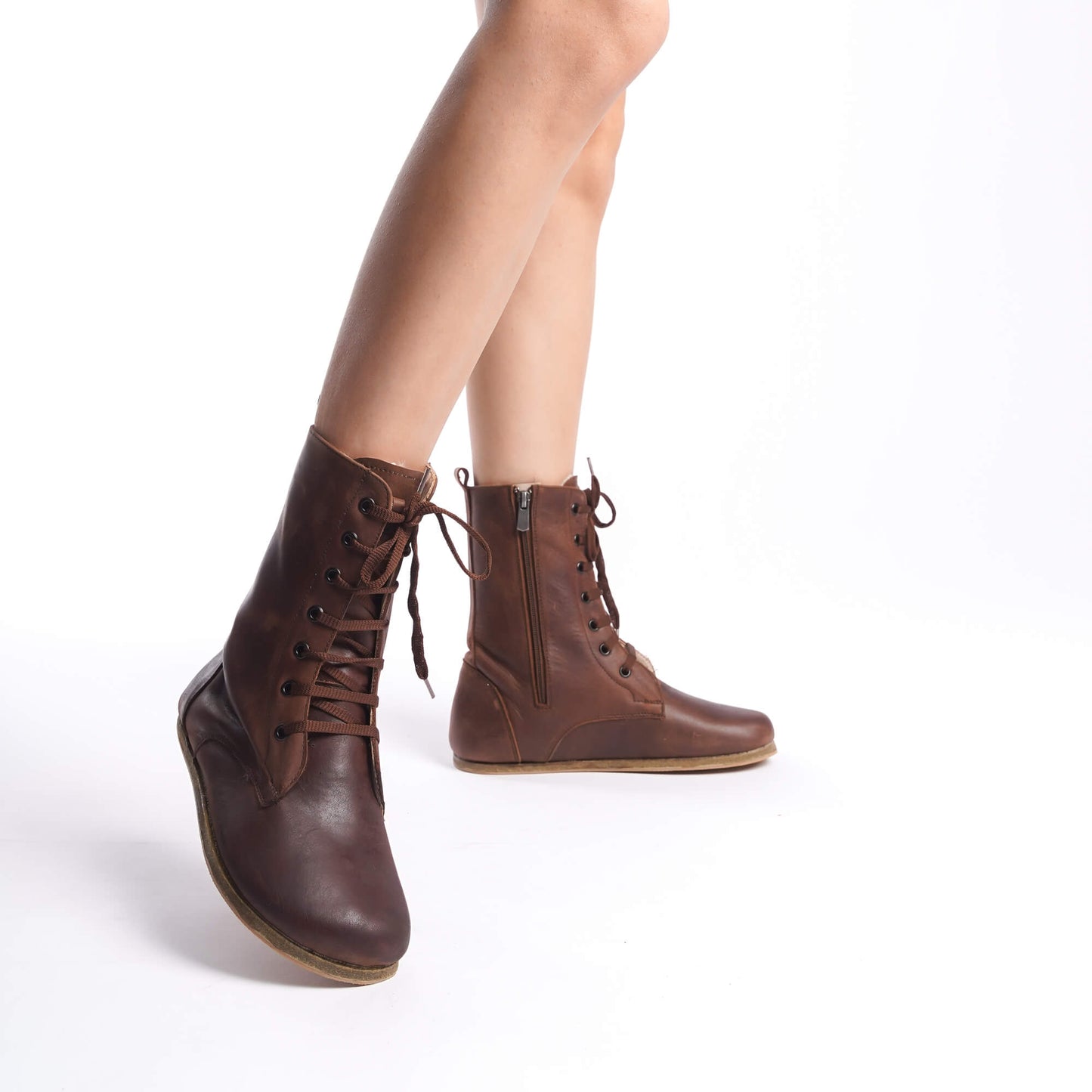 Brown-colored women's boots crafted from genuine natural leather. Featuring high ankle design and side zipper for style and comfort.