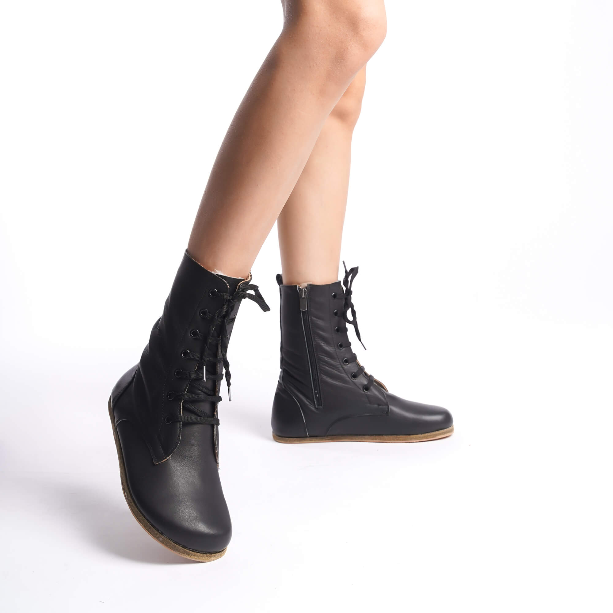 Black-colored women's boots crafted from genuine natural leather. Featuring high ankle design and side zipper for style and comfort.