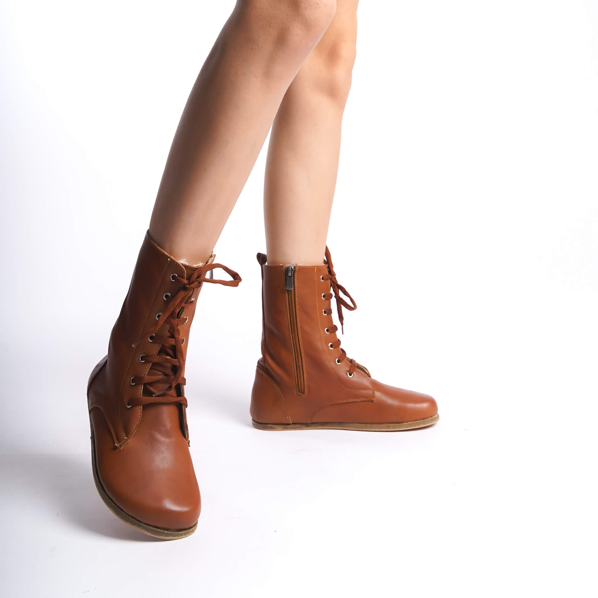 Tan brown women's boots crafted from genuine natural leather. Featuring high ankle design and side zipper for style and comfort.