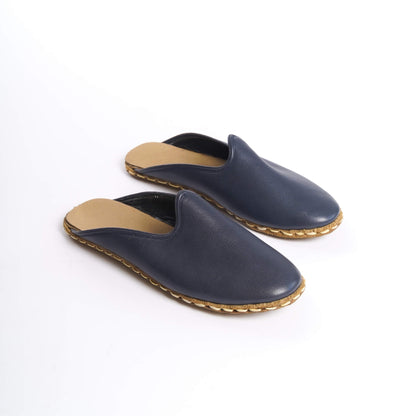 Close-up of navy blue leather slippers with natural genuine leather soles.