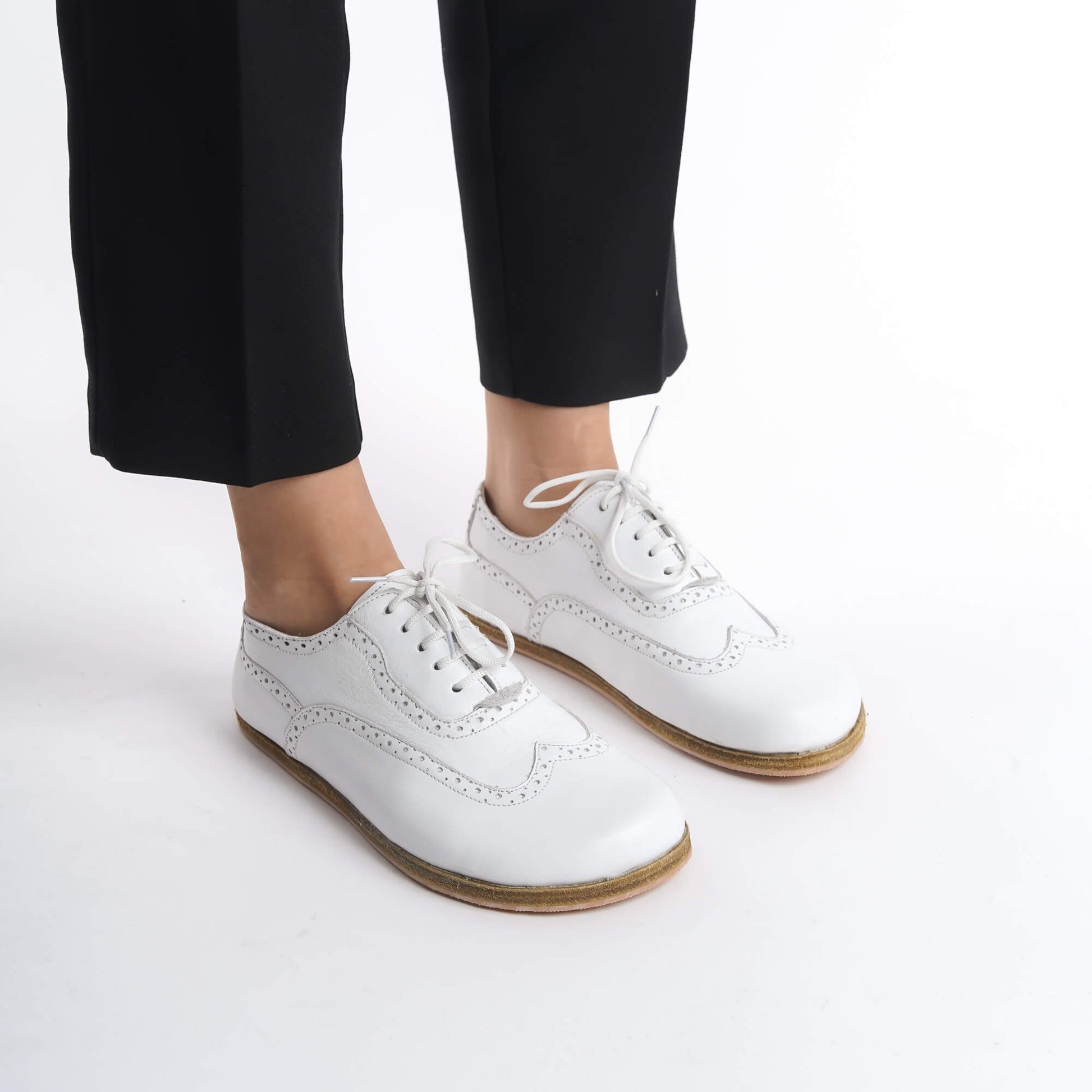 Close-up of White Doris Leather Barefoot Women Oxfords showcasing intricate brogue details, available at pelanir.com.