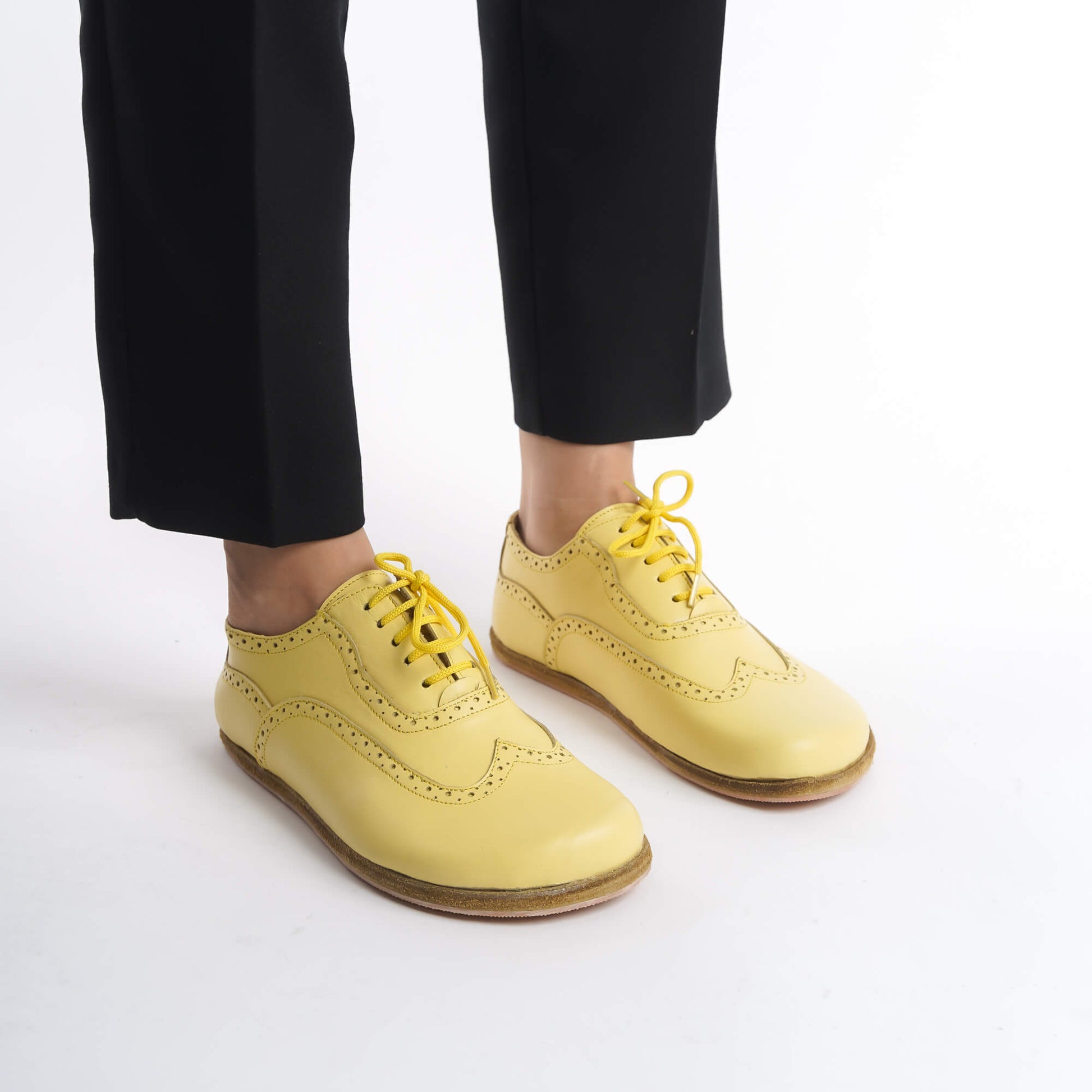 Close-up of yellow Doris Leather Barefoot Women Oxfords showcasing intricate brogue details, available at pelanir.com.