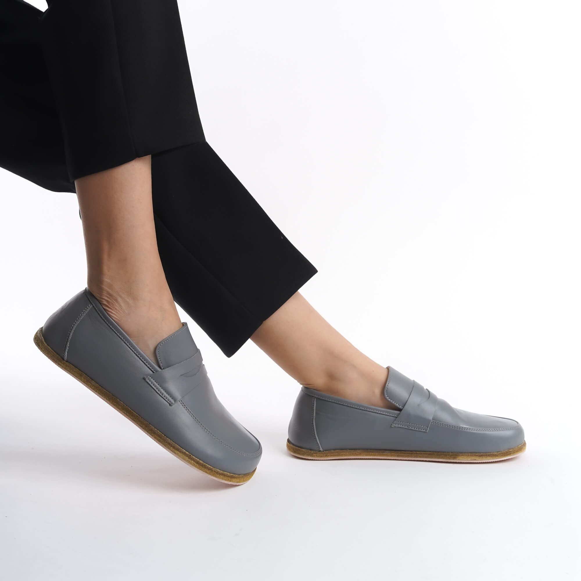 Side view of Pelanir Sardis gray full-grain leather barefoot penny loafer. Soft yet durable leather, a flexible sole, and a wide toe box ensure maximum comfort.