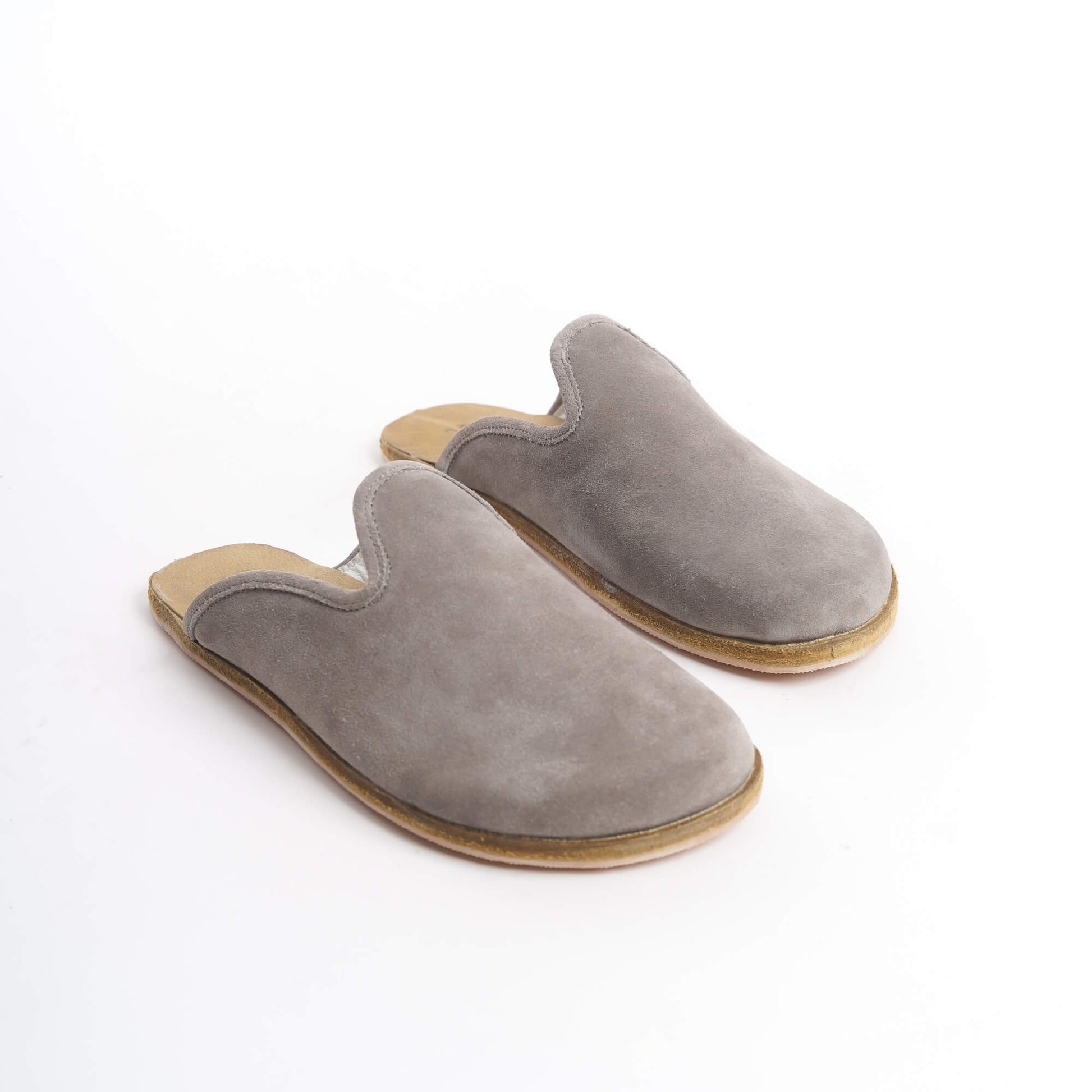 Trendy gray suede leather slip-on shoes with a cushioned cork sole, ideal for women seeking fashionable and comfortable footwear. These eco-friendly shoes blend style and durability, appealing to the U.S. fashion market.