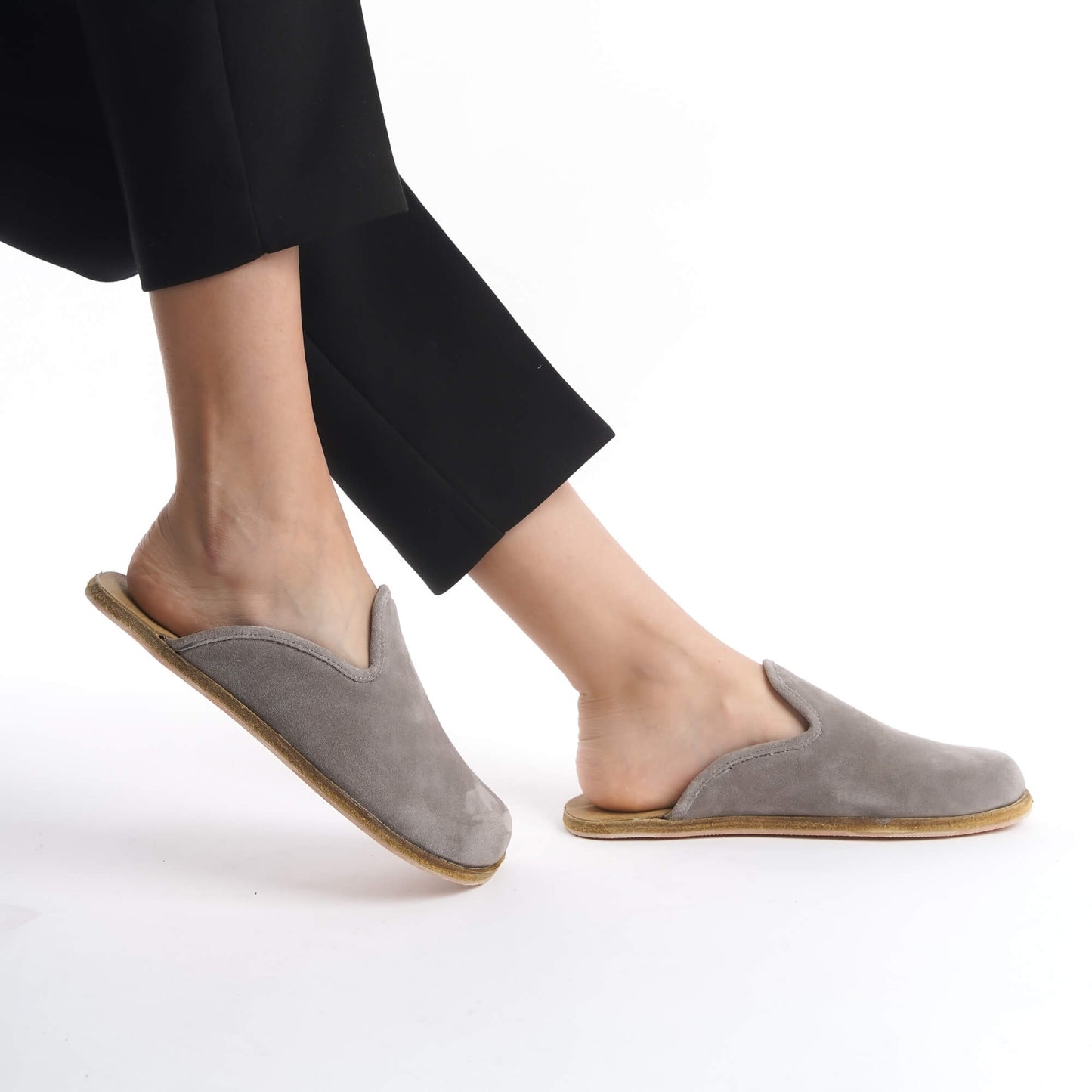 Modern gray suede leather slip-on shoes with a supportive cork sole, designed for women who value comfort and sustainability. Ideal for the U.S. market, these lightweight shoes elevate any outfit with a minimalist touch.