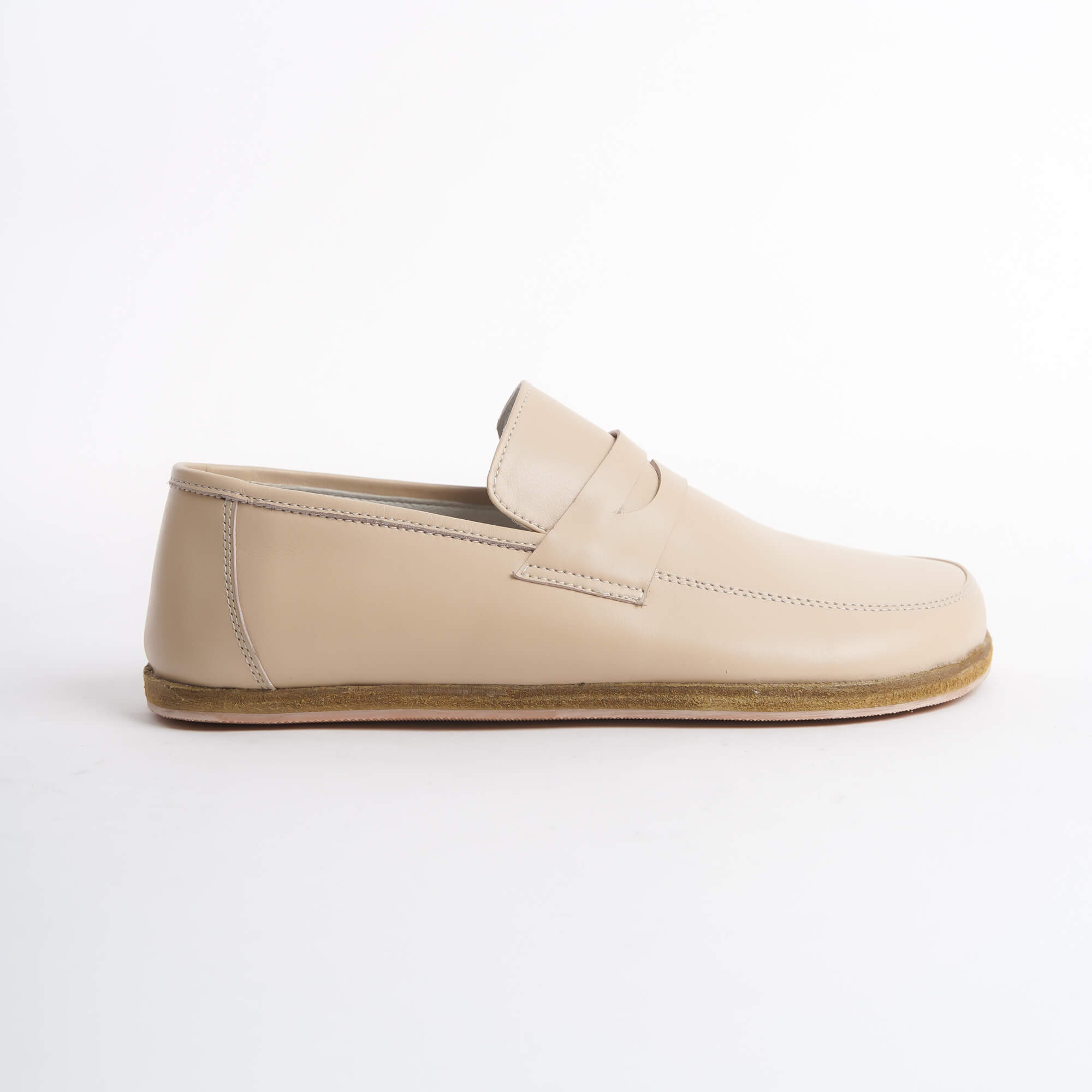 Close-up of Pelanir Sardis beige barefoot penny loafers. Soft leather, lightweight construction, and a flexible zero-drop sole for ultimate comfort.