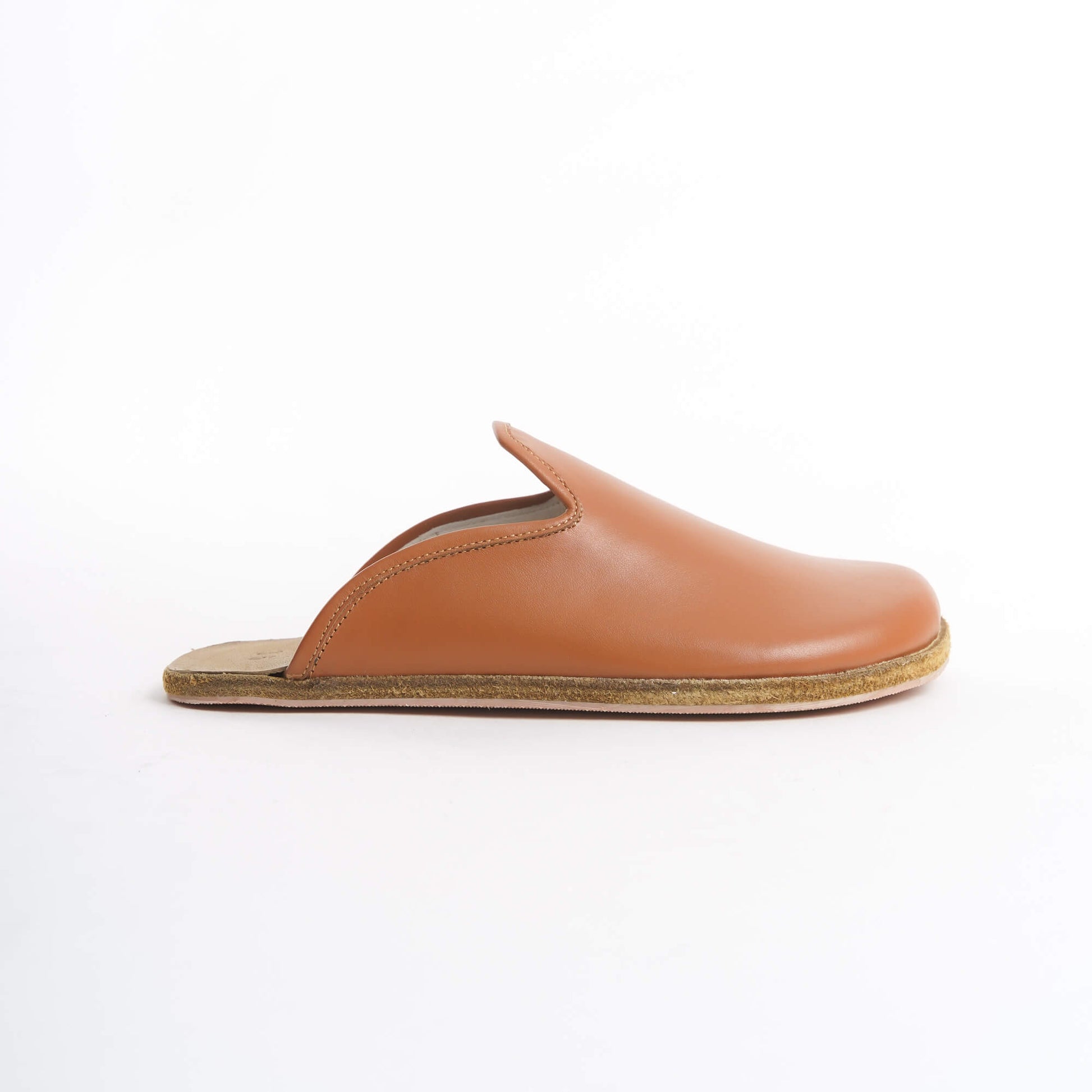 Warm tan leather slip-on shoes for women, featuring a cushioned cork sole for exceptional comfort. These eco-friendly and versatile shoes are perfect for U.S. fashion lovers seeking stylish everyday wear.