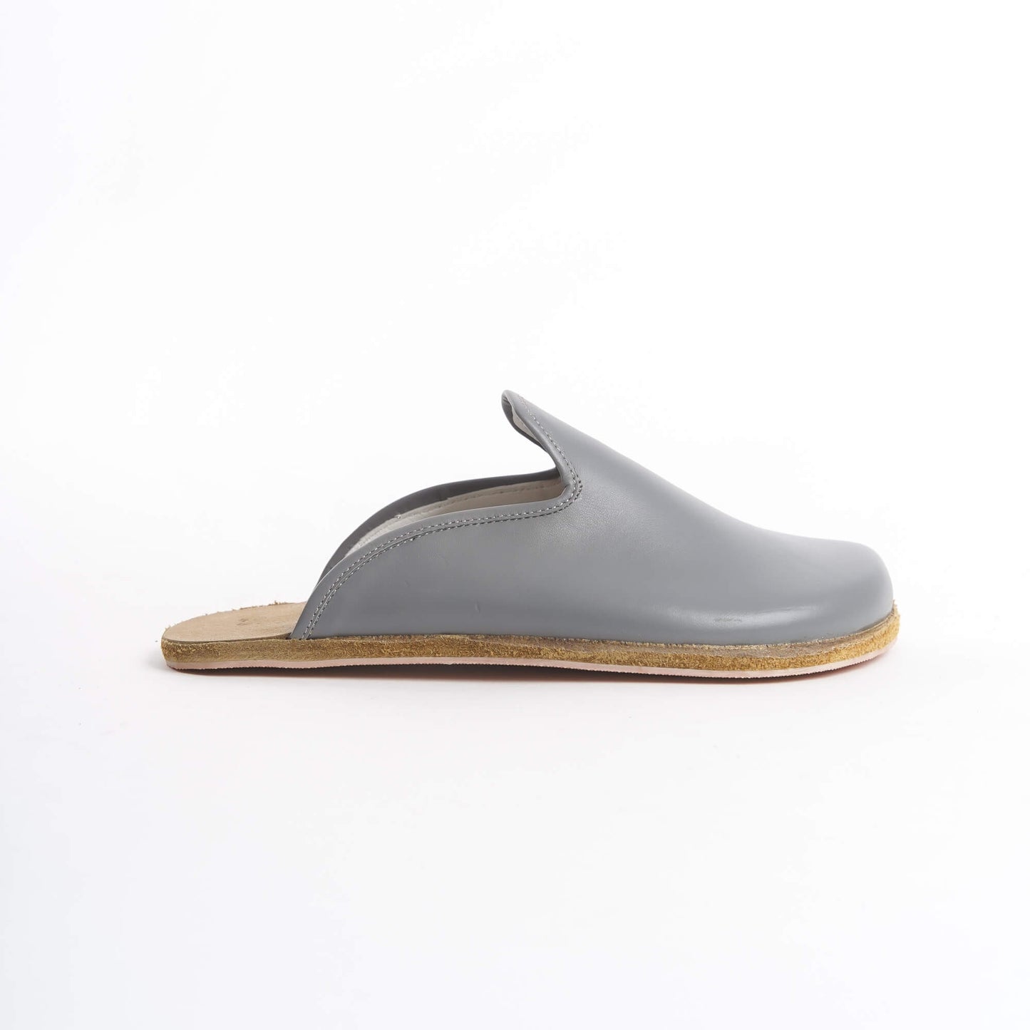 Sleek gray leather slip-on shoes for women, featuring a cushioned cork sole for all-day comfort. These eco-friendly and stylish shoes are perfect for U.S. professionals and casual wearers seeking versatile footwear.