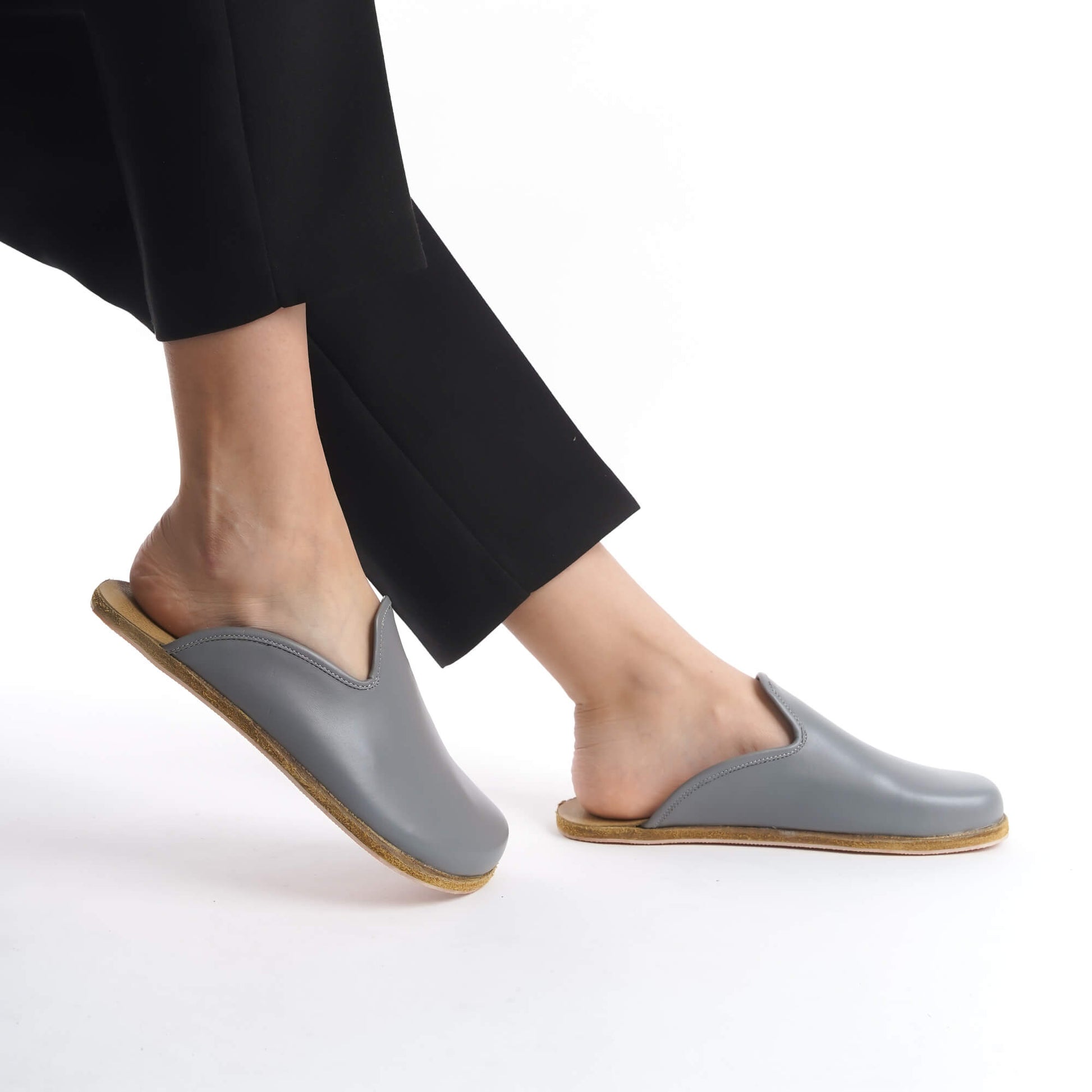 Modern gray leather slip-on shoes with a supportive cork sole, designed for women who value comfort and sustainability. Ideal for the U.S. market, these lightweight shoes elevate any outfit with a minimalist touch.