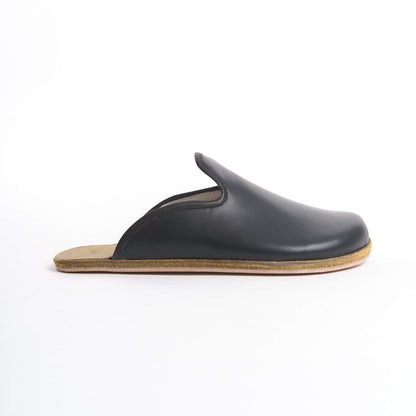 Classic black leather slip-on shoes for women, featuring a cushioned cork sole for all-day comfort. These eco-friendly and sleek shoes are perfect for U.S. professionals and casual wearers.