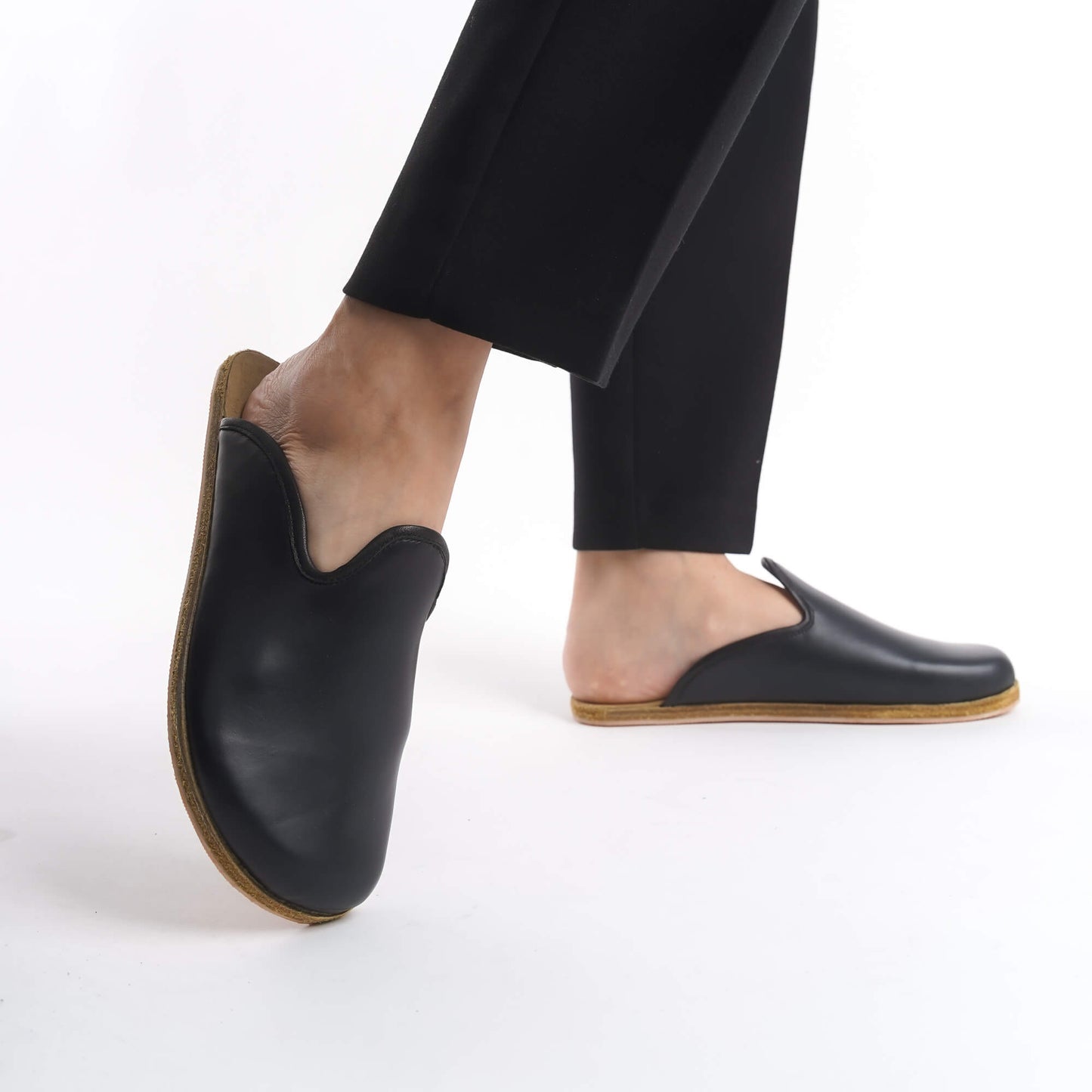 Sophisticated black leather slip-on shoes for women, crafted with a natural cork sole for excellent support. These durable and eco-conscious shoes are ideal for everyday use in the USA.