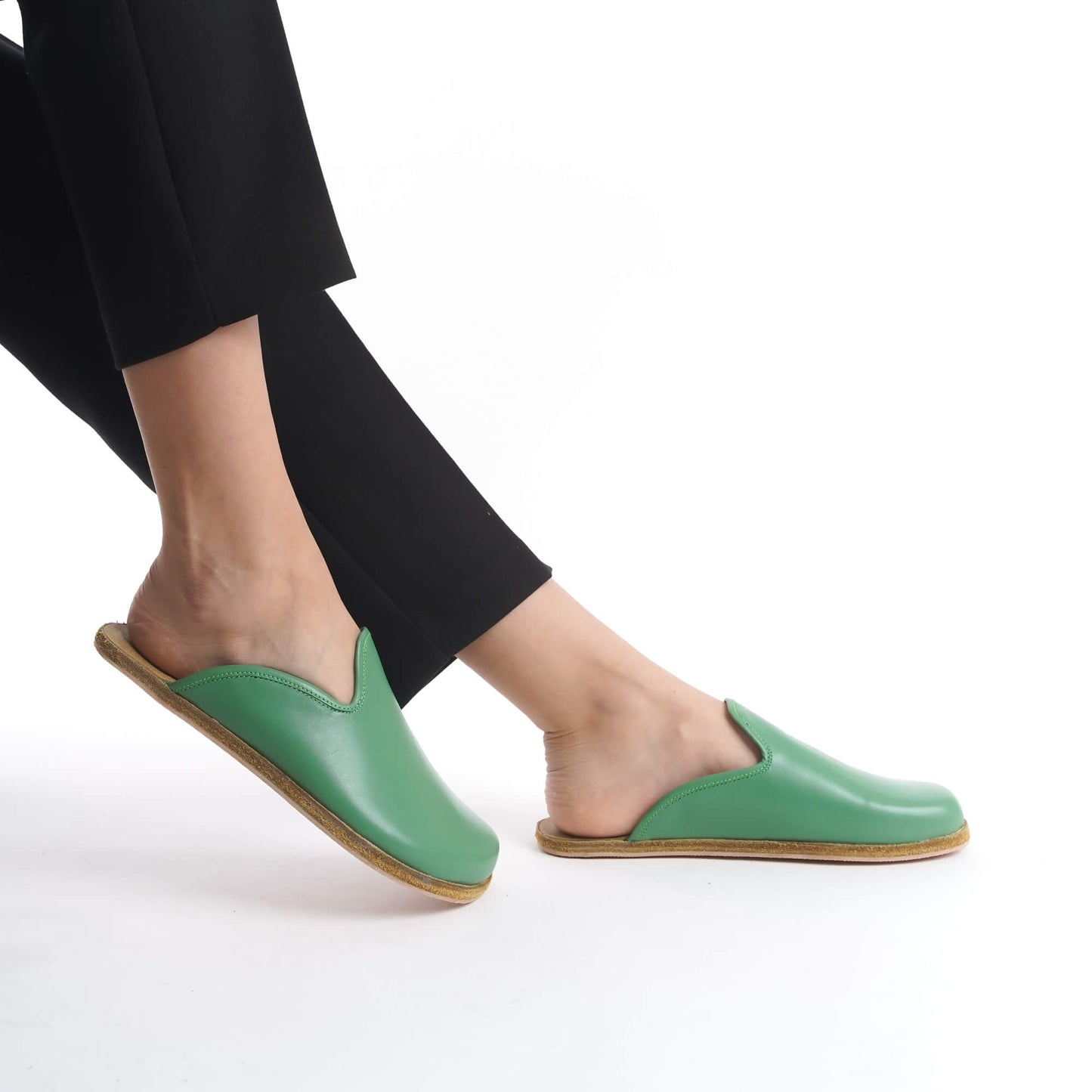 Fresh green leather slip-on shoes with a natural cork sole, designed for women who embrace sustainable fashion. These lightweight, breathable shoes add a pop of color to any U.S. outfit.