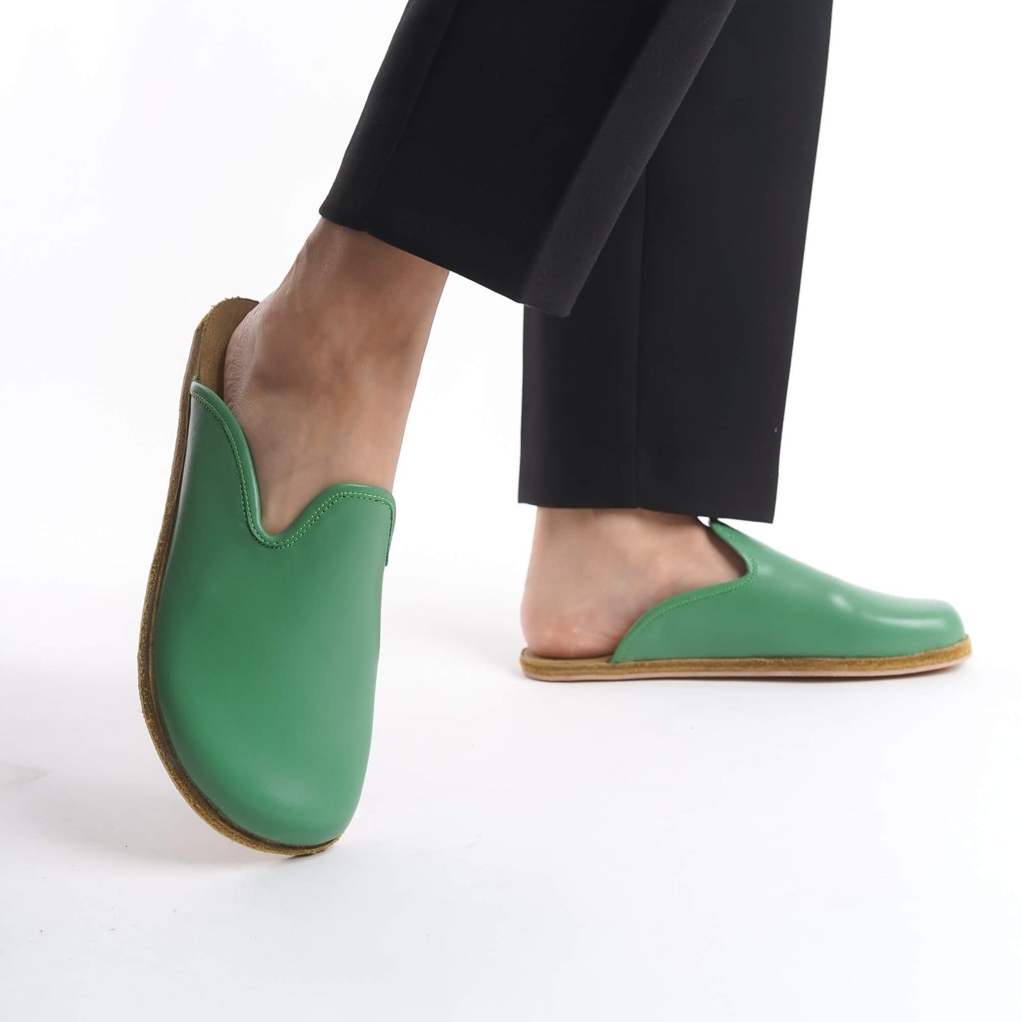 Lively green leather slip-on shoes for women, crafted with a cushioned cork sole for excellent support. These durable and eco-conscious shoes are perfect for casual wear in the USA.