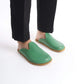 Stylish green leather slip-on shoes featuring a cozy cork sole, perfect for women seeking unique comfort. These sustainable shoes offer versatility and flair, appealing to U.S. fashion enthusiasts.