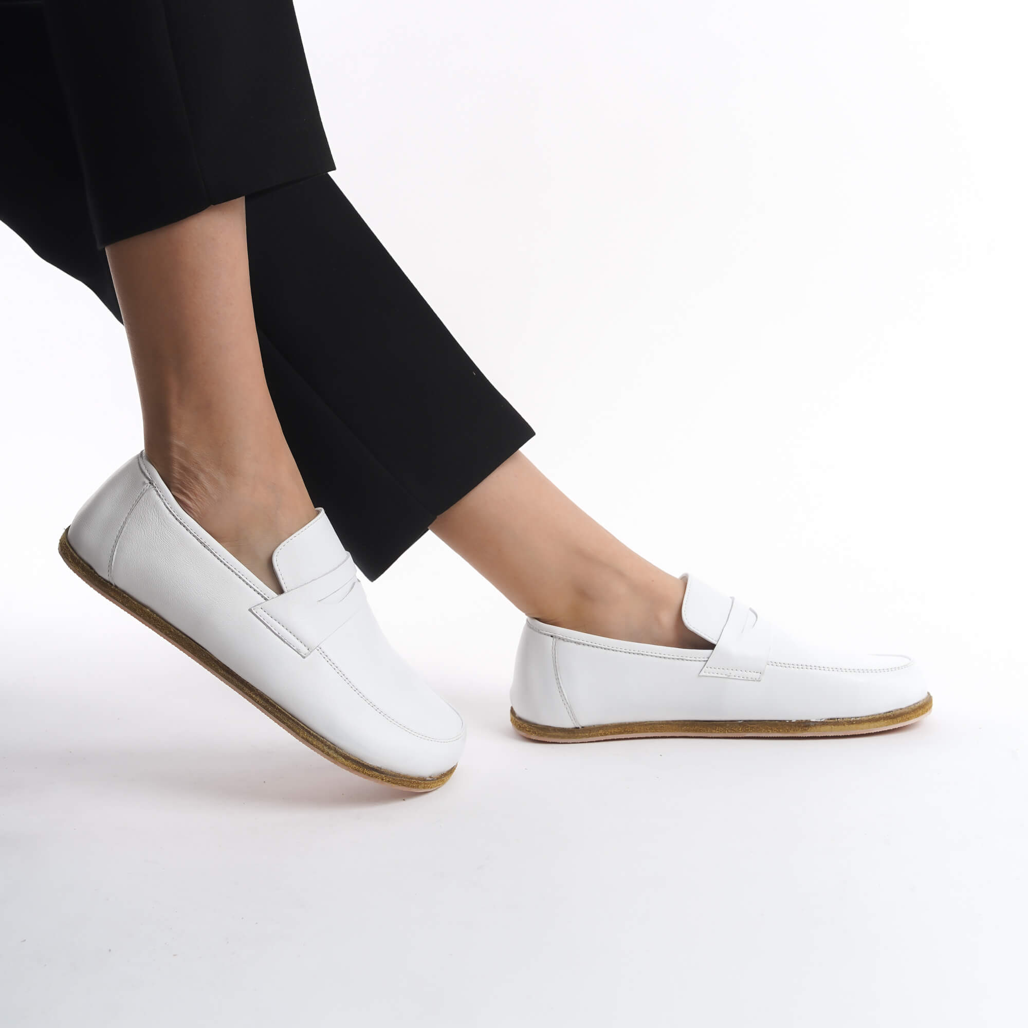 Side view of Pelanir Sardis white barefoot penny loafer. Crafted from premium full-grain leather with a wide toe box and flexible sole for maximum comfort.