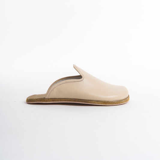 Luxurious cream leather slip-on shoes for women, featuring a cushioned cork sole for all-day comfort. These eco-friendly and elegant shoes are perfect for U.S. fashion enthusiasts seeking versatile everyday wear.