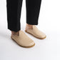 Stylish cream leather slip-on shoes featuring a cozy cork sole, perfect for women’s sophisticated looks. These sustainable shoes offer flexibility and comfort, appealing to U.S. shoppers.