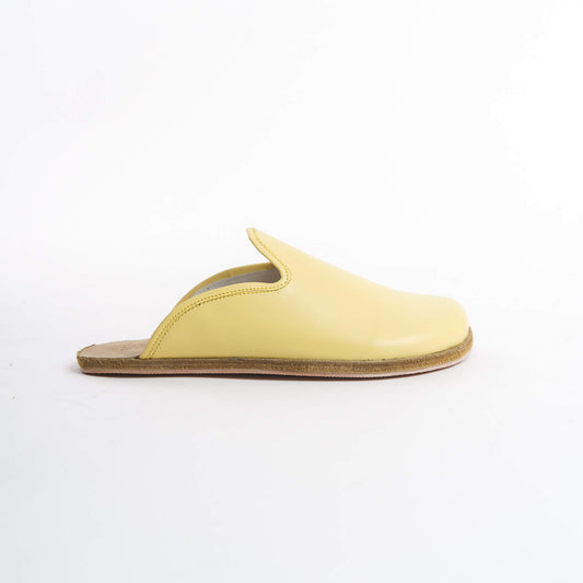 Bold yellow leather slip-on shoes for women, featuring a supportive cork sole for lasting comfort. These eco-friendly and vibrant shoes are ideal for U.S. trendsetters looking to stand out.