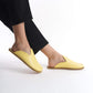 Bright yellow leather slip-on shoes with a natural cork sole, designed for women who love colorful, sustainable footwear. These lightweight shoes add a pop of style to any U.S. outfit.