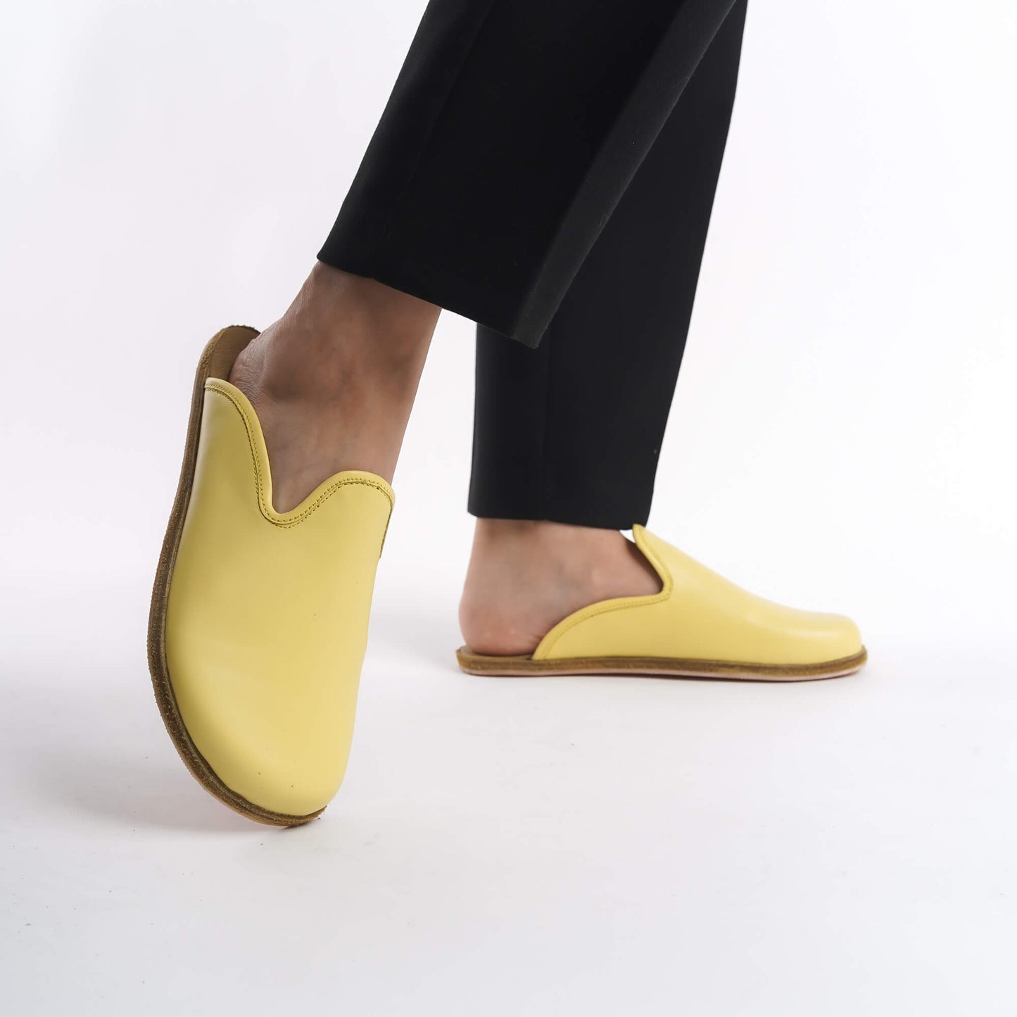 Eye-catching yellow leather slip-on shoes for women, crafted with a cushioned cork sole for superior support. These durable and eco-conscious shoes are perfect for casual wear in the USA.