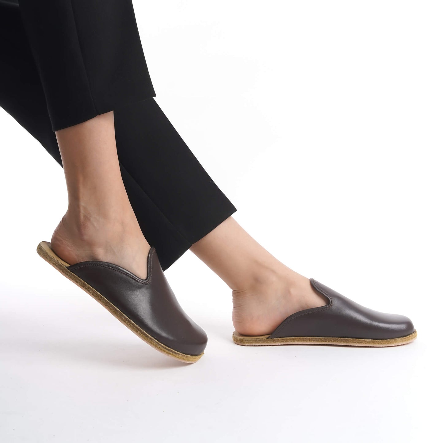 Warm brown leather slip-on shoes with a natural cork sole, designed for women who prioritize style and sustainability. These lightweight, breathable shoes are a versatile addition to any U.S. wardrobe.