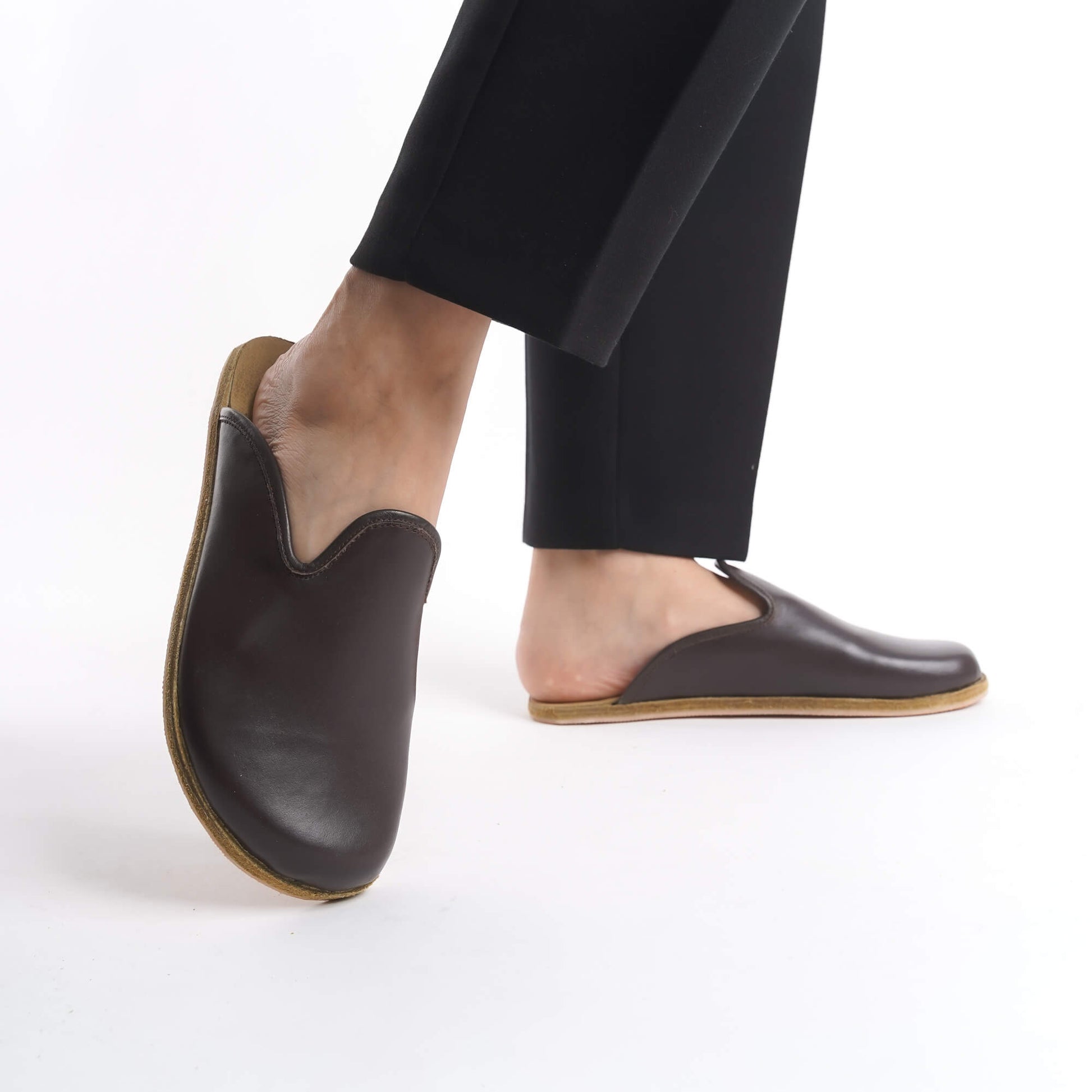 Classic brown leather slip-on shoes for women, crafted with a cushioned cork sole for superior support. These eco-conscious and durable shoes are ideal for all-day wear, appealing to U.S. customers.