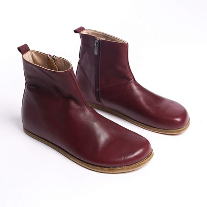 Pair of men's burgundy ankle boots, made from genuine leather with a side zipper for a sophisticated and comfortable fit.