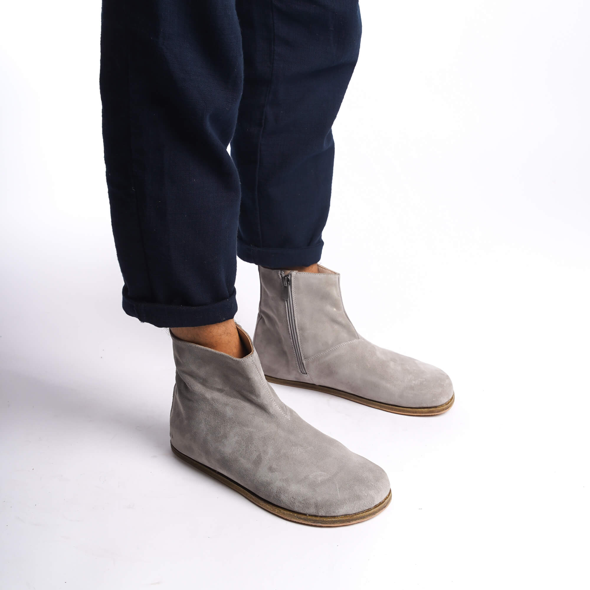Side view of men's gray ankle boots, highlighting the minimalist design and high-quality leather material.
