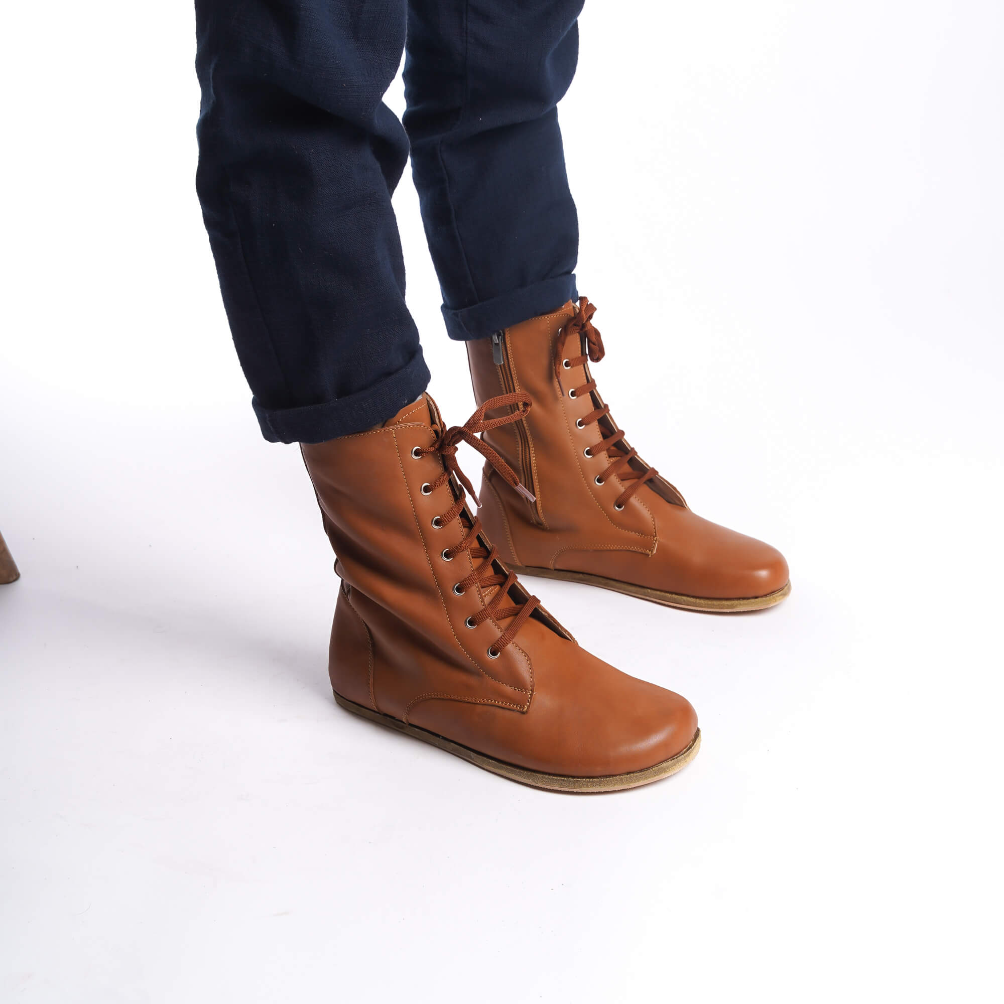 Side view of men's tan brown barefoot boots, showcasing the lace-up design and quality leather.