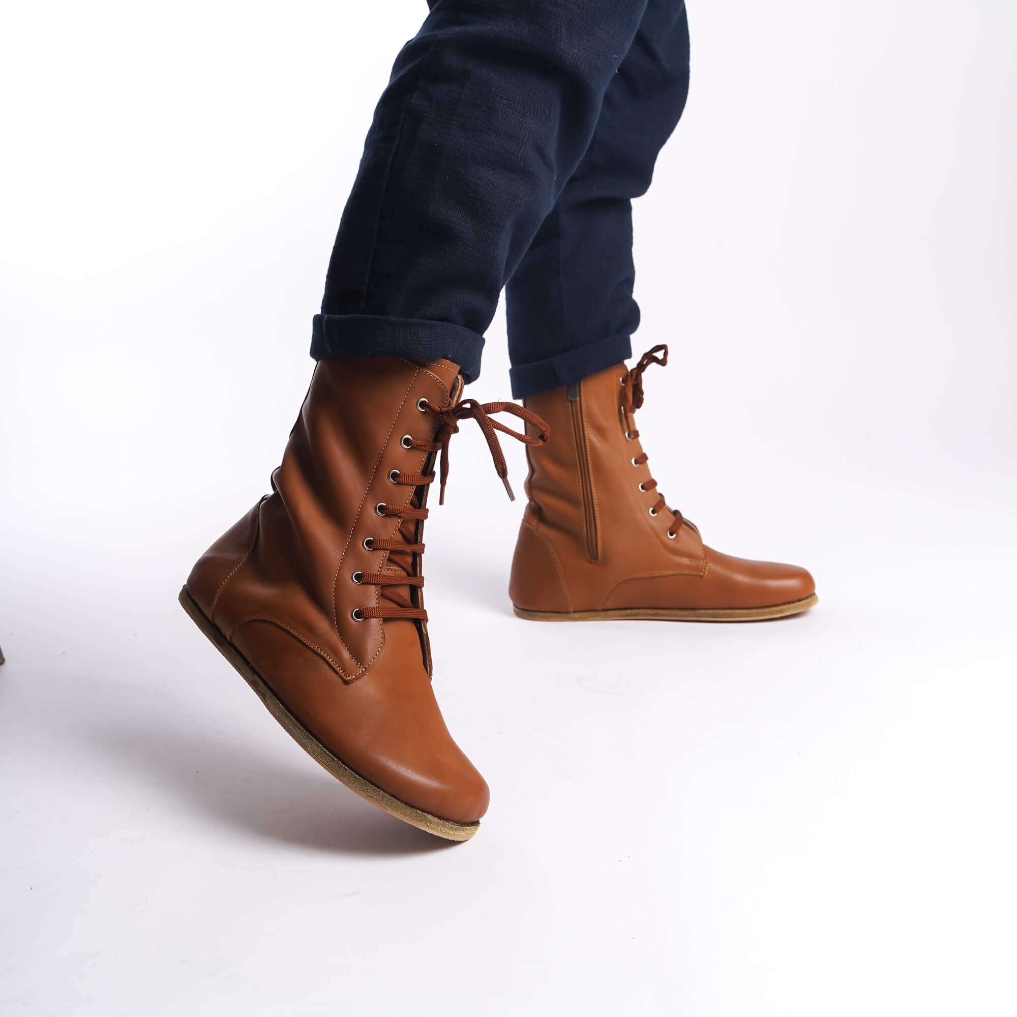 Tan brown leather barefoot boots for men, side profile with a zipper, ideal for winter wear.