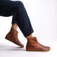 Side view of men's tan brown ankle boots, highlighting the minimalist design and top-quality leather.