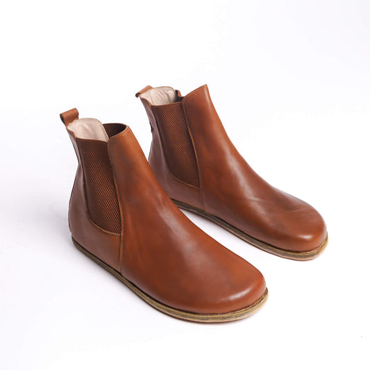 Pair of men's tan brown Chelsea boots, made from genuine leather with elastic side panels for a chic and comfortable fit.