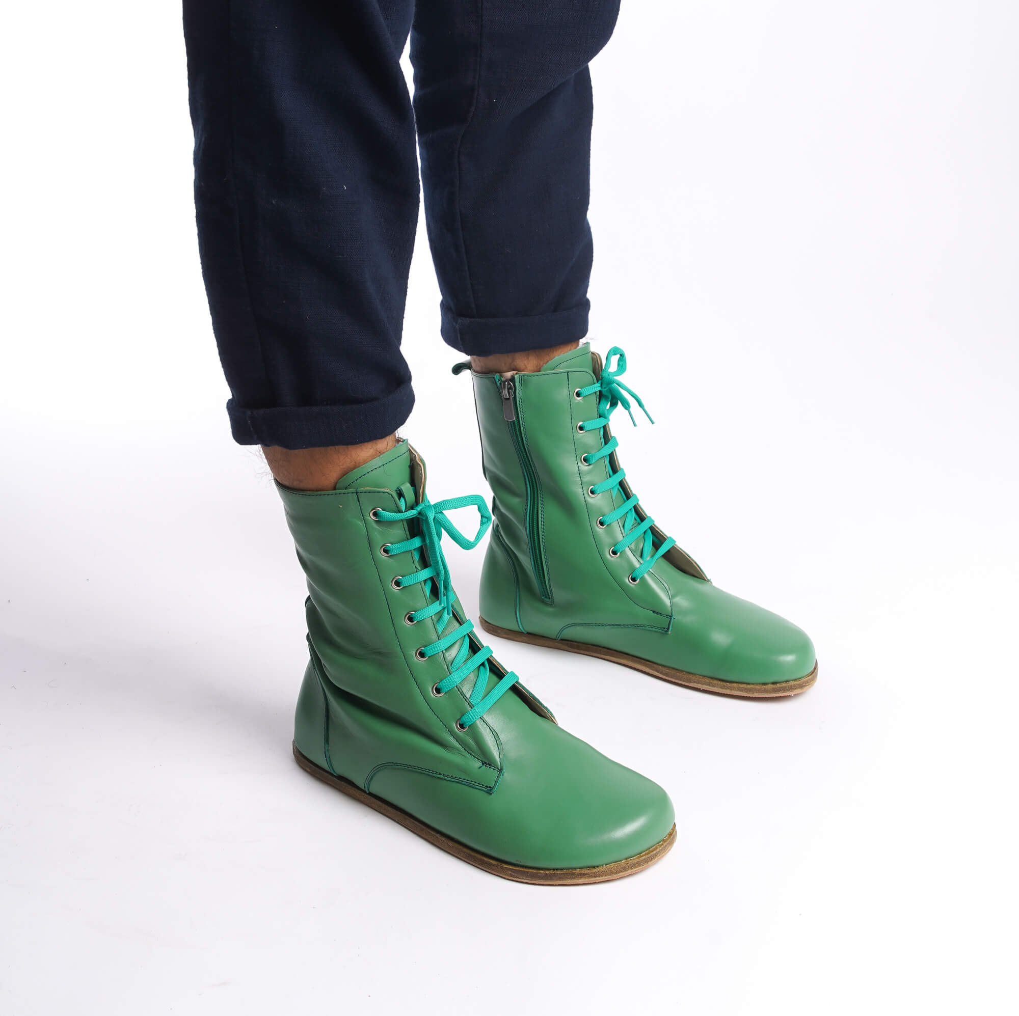 Side view of men's green barefoot boots, highlighting the lace-up design and premium leather.