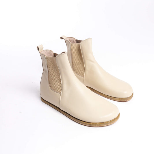 Pair of men's beige-cream Chelsea boots, crafted from genuine leather with elastic side panels for a stylish and comfortable fit.