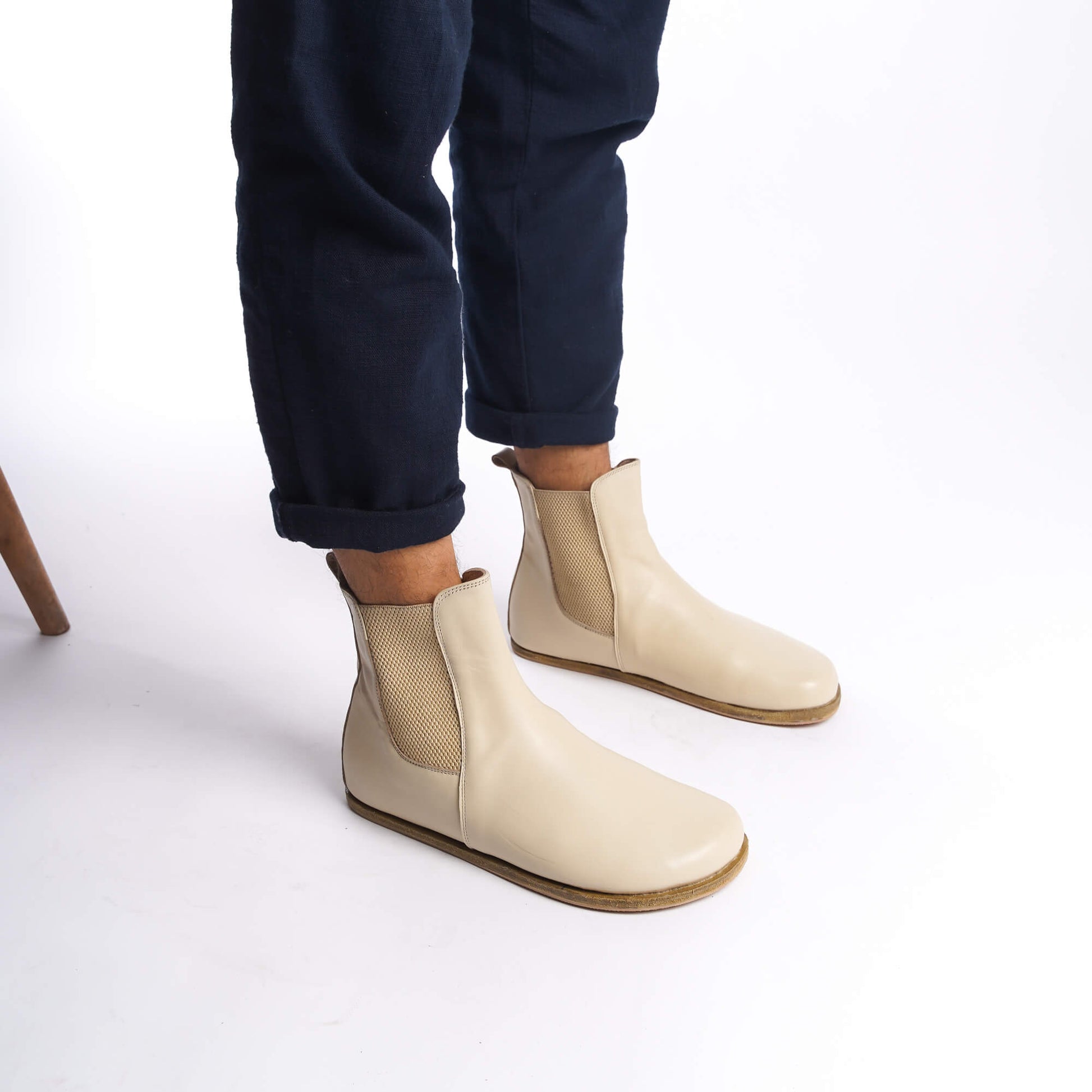 Side view of men's beige-cream Chelsea boots, highlighting the minimalist design and high-quality leather.