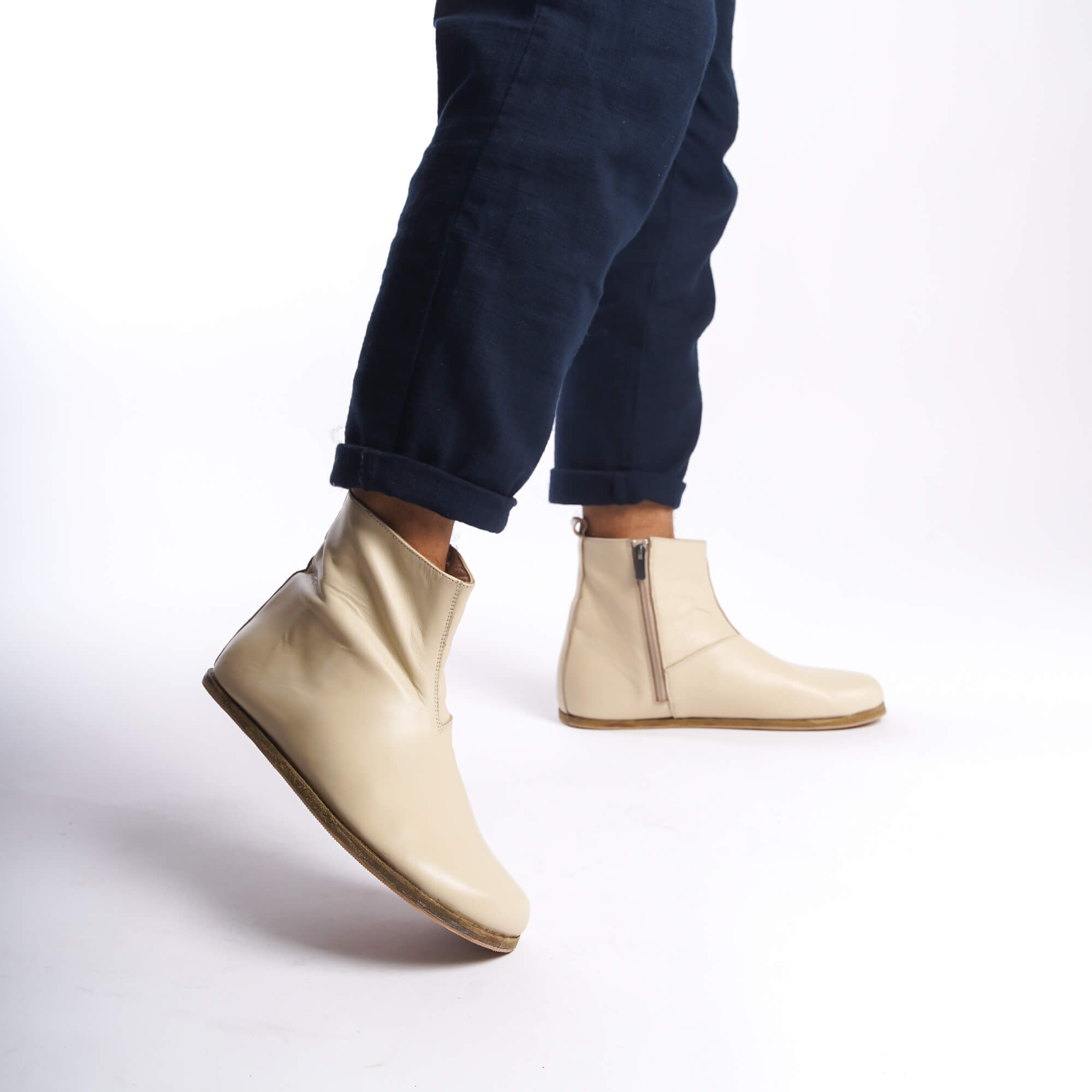Side view of men's beige-cream ankle boots, highlighting the minimalist design and high-quality leather material.